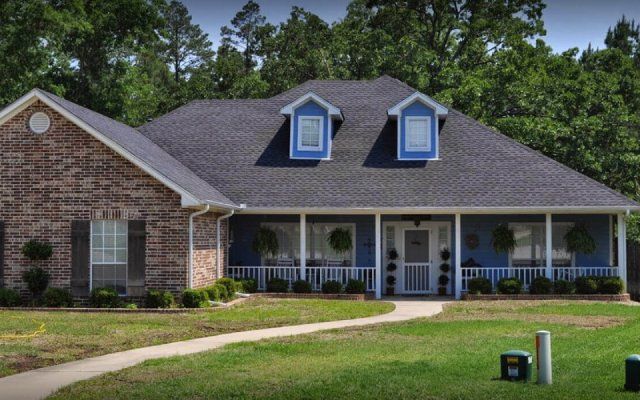 Brick house with blue front porch in Tyler