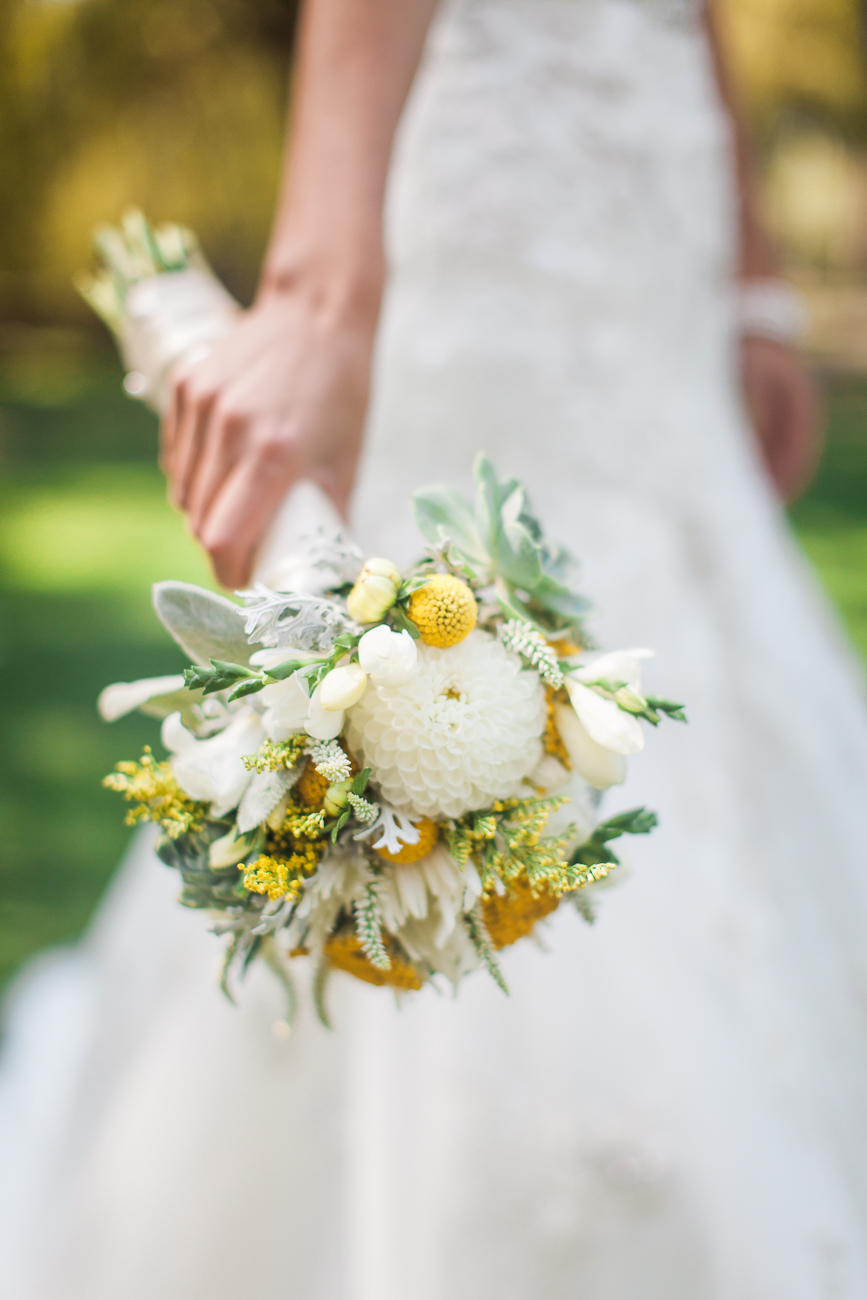 a closeup of a bridal bouquet with white and yellow flowers
