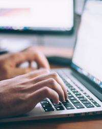 Hands typing on keyboard