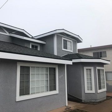 grey stucco home with white painted trim