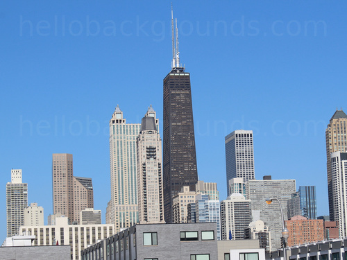 Urban cityscape at mid-day featuring various tall buildings with one prominent black coloured building in centre Microsoft Teams background