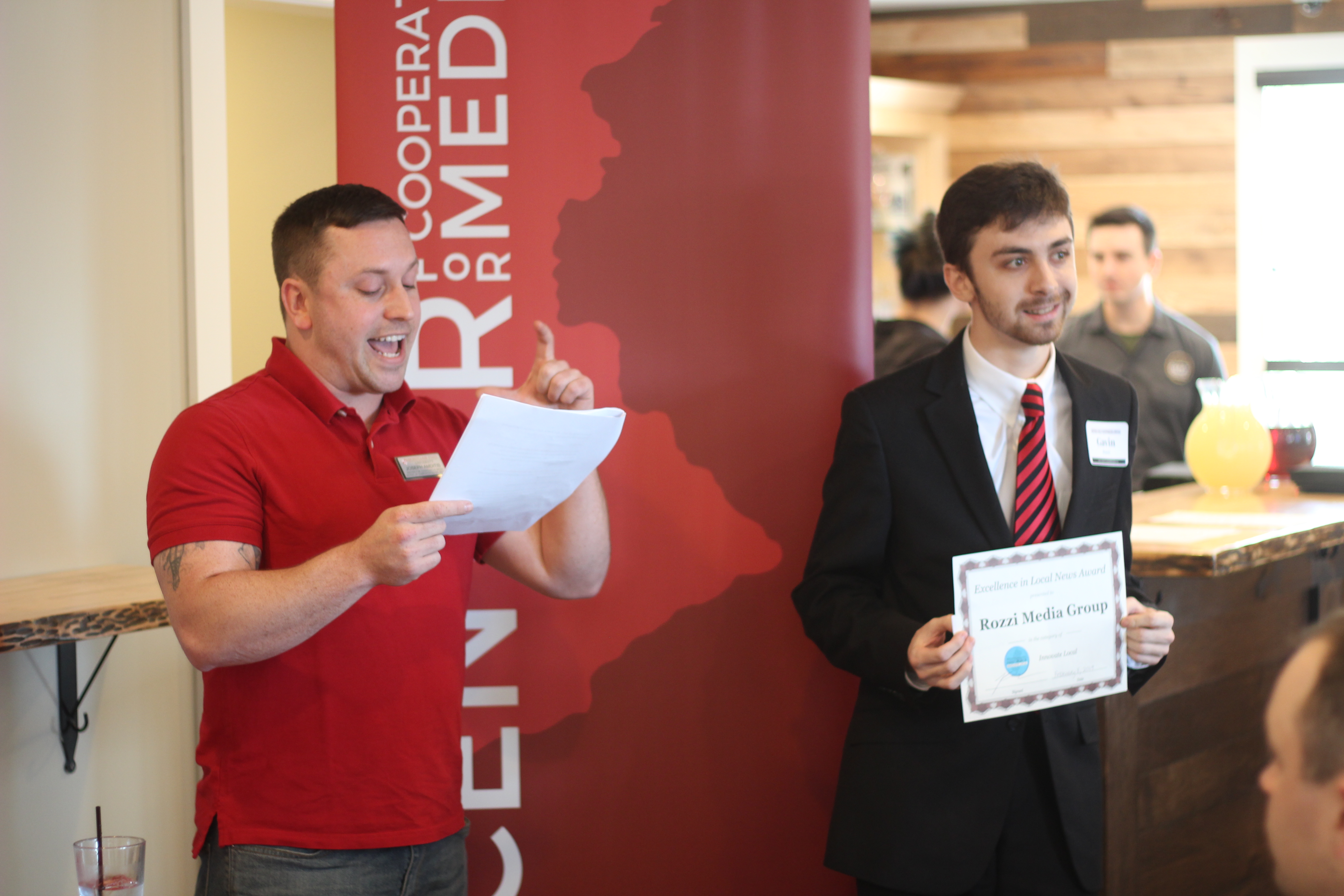 Gavin Rozzi, holding the Excellence in Local News Award