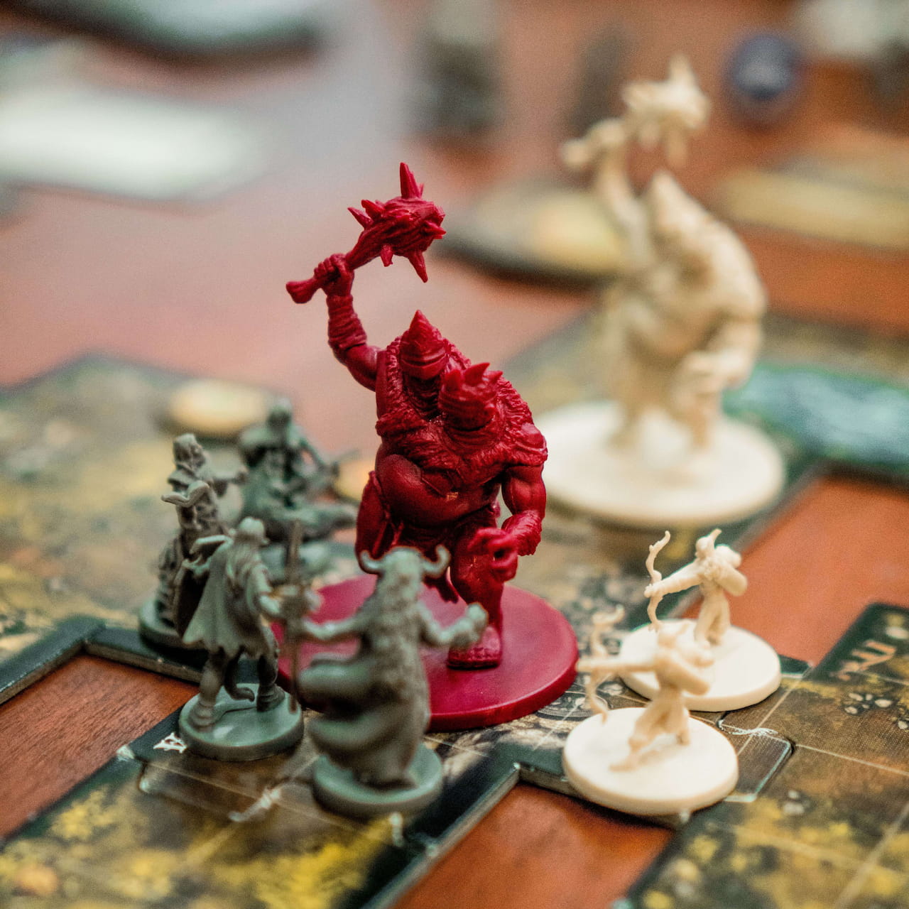 Some board game pieces on a table representing characters in battle.