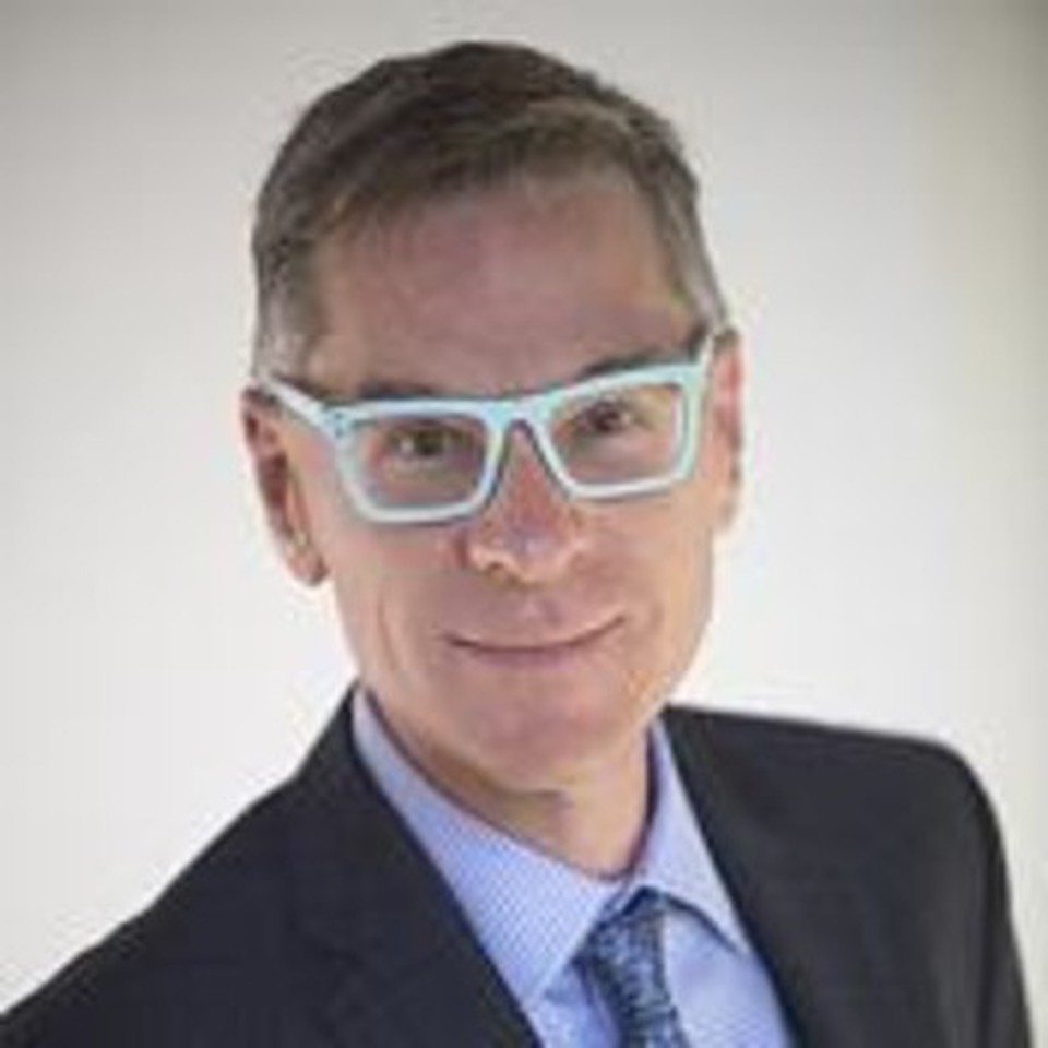Dean Bornick - in a suit with light blue glasses