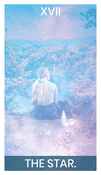 The Star card. A woman sits on a dirt cliff edge, looking out on a lake and forest.