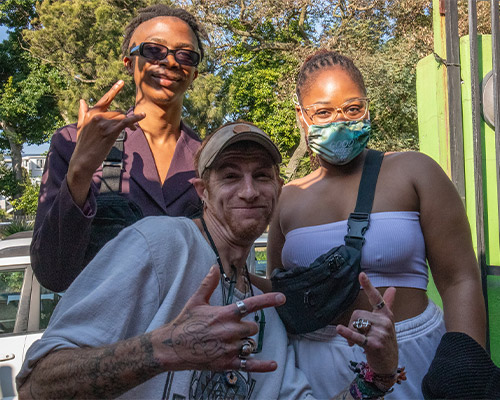 Three attendees smiling and posing