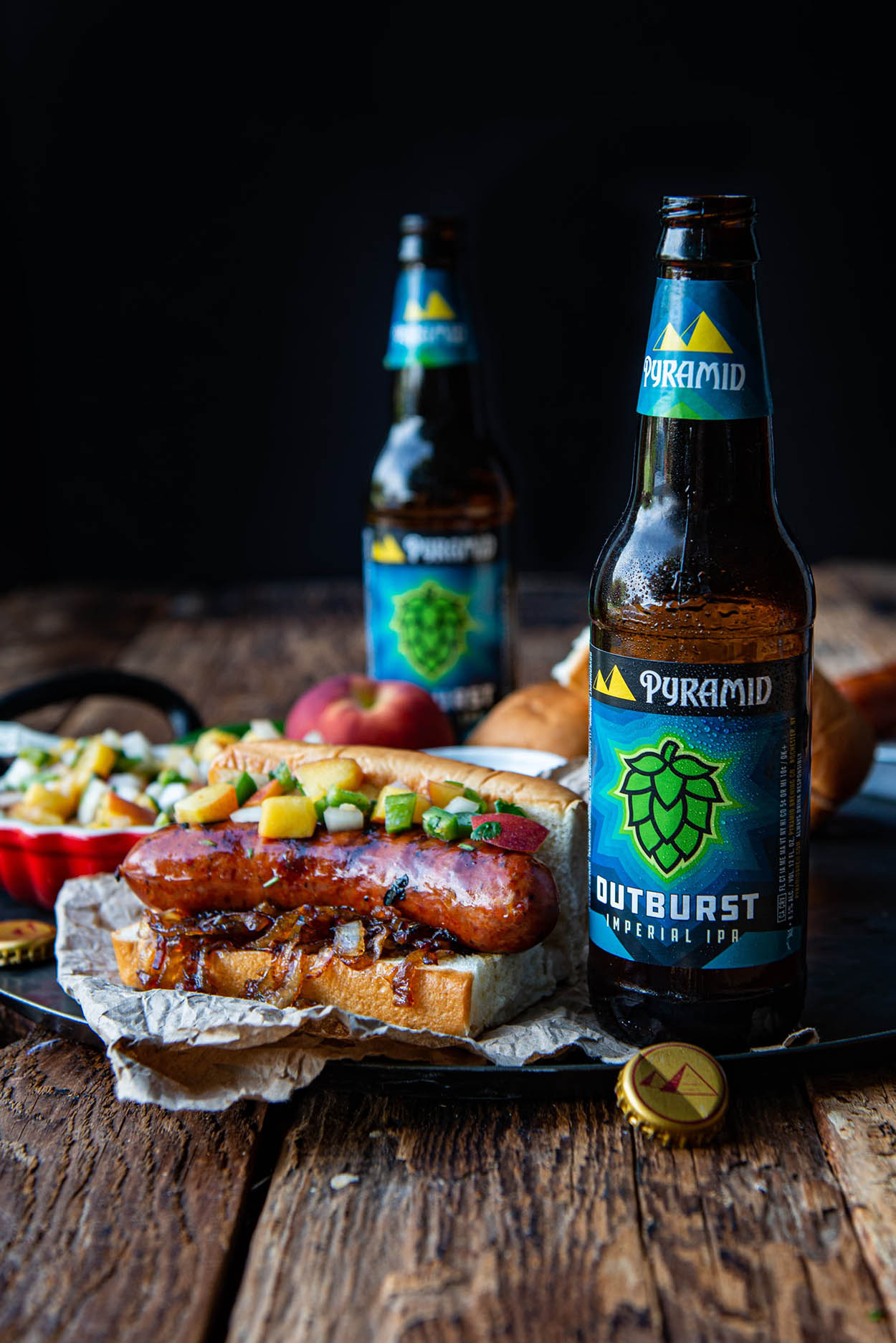 Best homemade beer brat, bratwurst with IPA carmelized onions and fresh salsa a photo of delicious homecooked bratwurst served with spicy homemade peach salsa and topped with carmelized onions, all served with a cold bottle of Outburst IPA