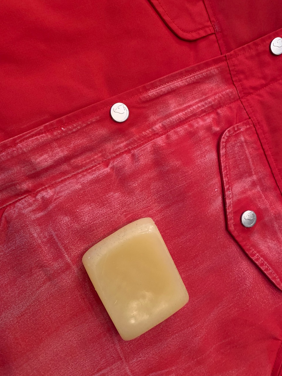 A red jacket with half of it waxed