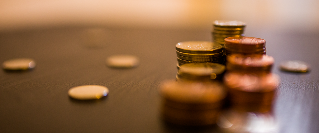 You know the old saying: 'Take care of the pennies... and you'll still only have pennies as our economy is in the toilet!' Some coins on a table