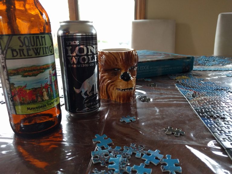 Squam Brewing and Lone Wolfe Brewing Company aid in finishing a puzzle.