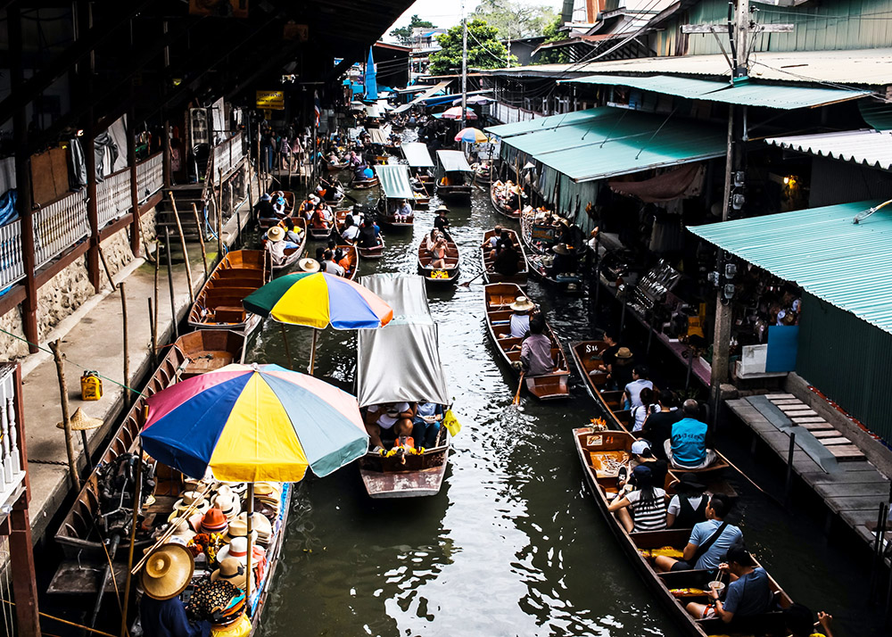 people in canoes on the canal in bangkok
