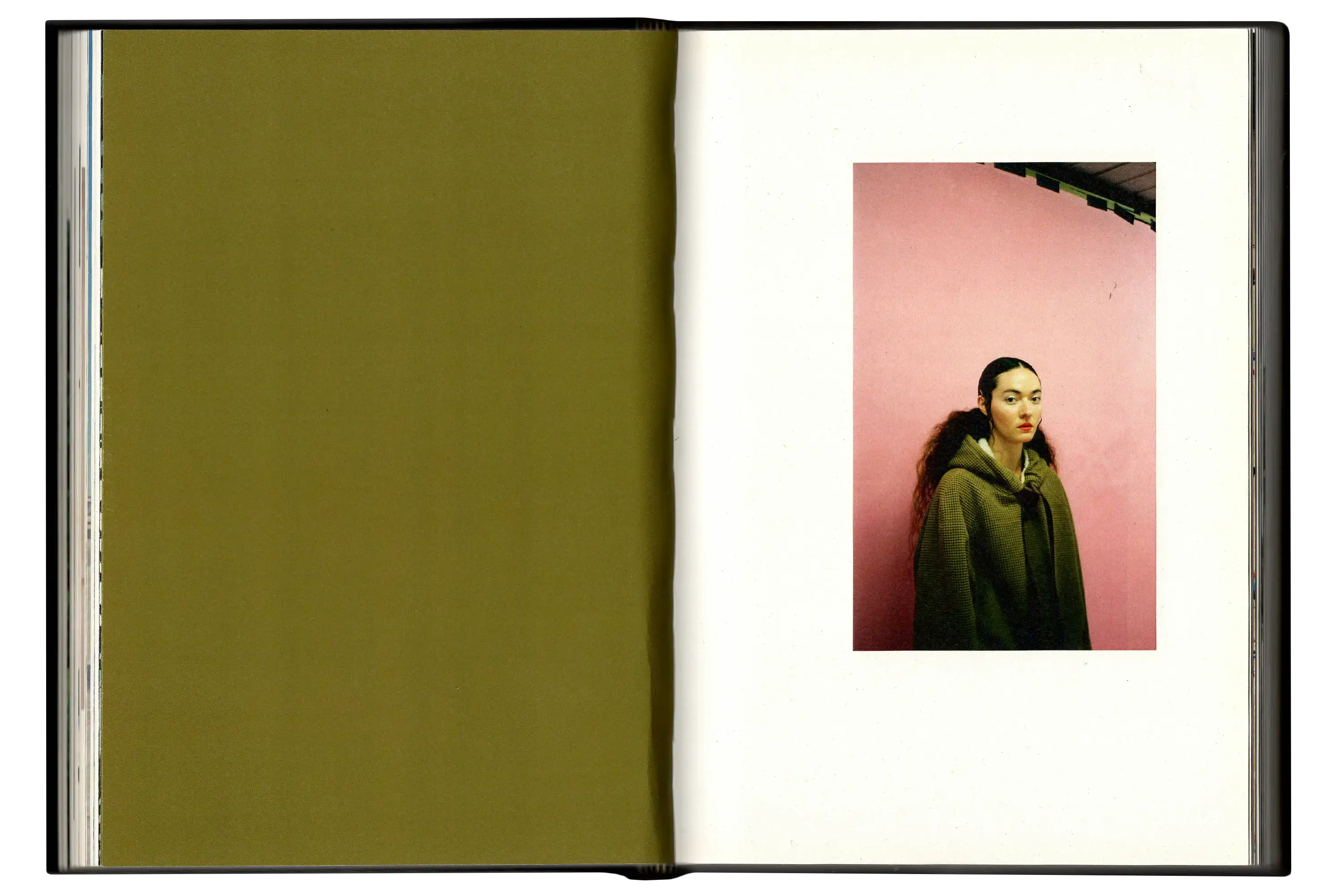 Imperfect Photo Book - left page deep brown/green colour, right page image of woman wearing similar colour coat in front of pink wall