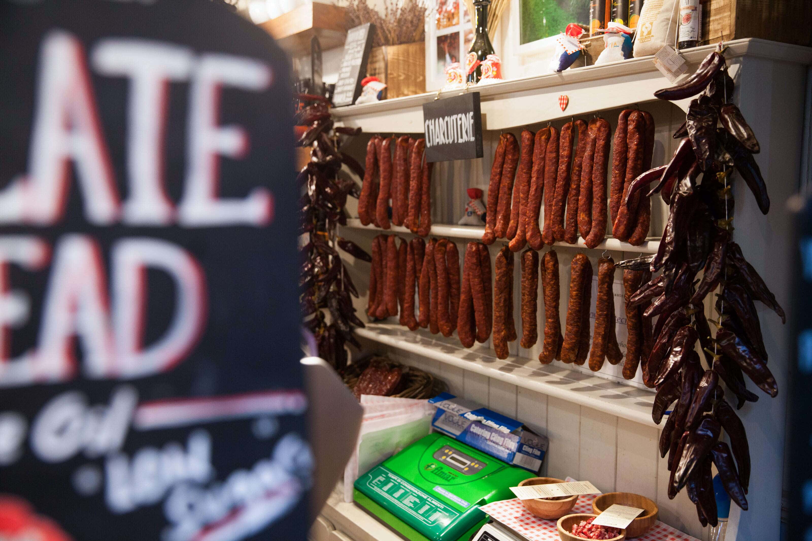 salami sausages hanging in a shop