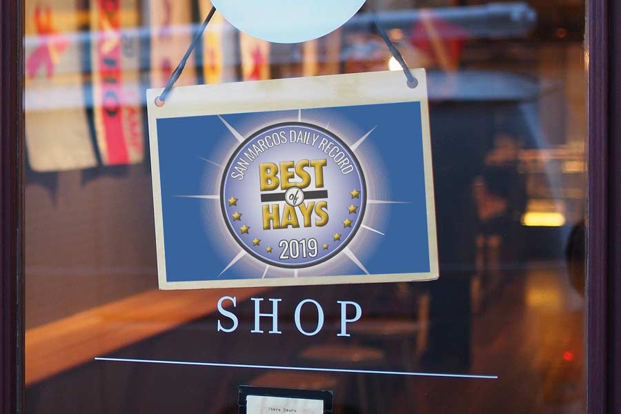 A store window with a Best of Hays sign