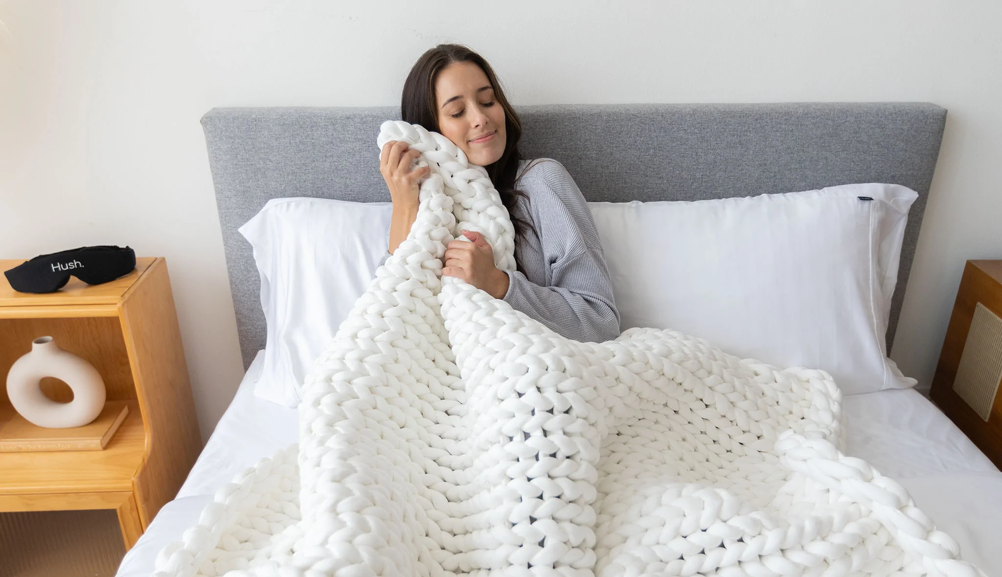 woman in bed with hush knit weighted blanket