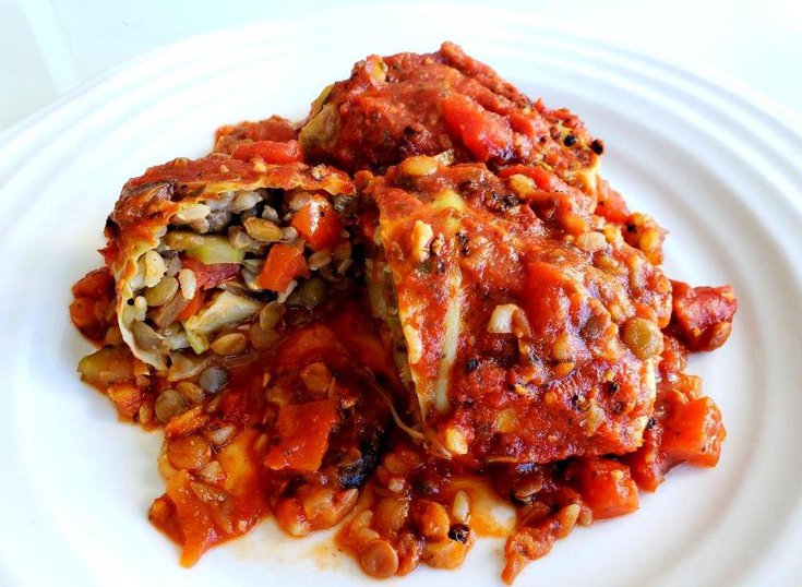 Plate with cabbage rolls stuffed with lentils, and brown rice