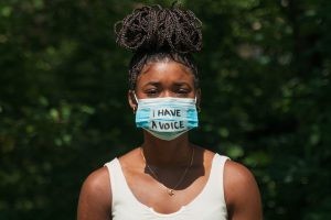 Woman Wears Face Mask With Protest Message