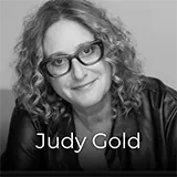 Picture of the comedian Judy Gold looking into the camera whilst smiling.