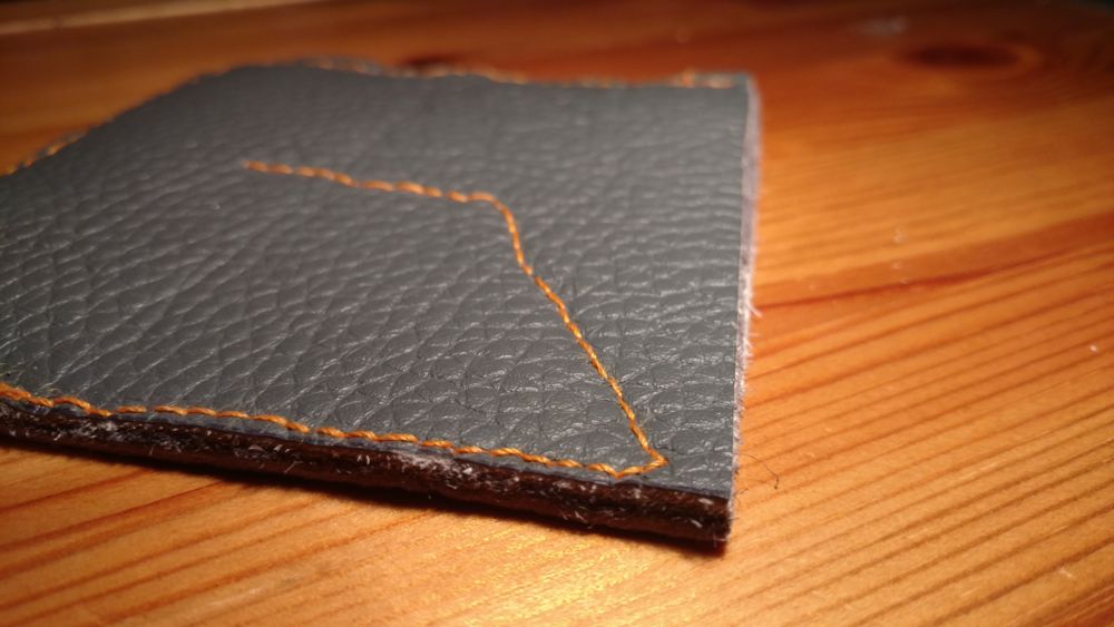 A close up picture of the stitching on the finished coin wallet