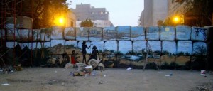 [A landscape mural of Luxor by Alaa Awad and friends on Kasr al-Eini Street wall.]
