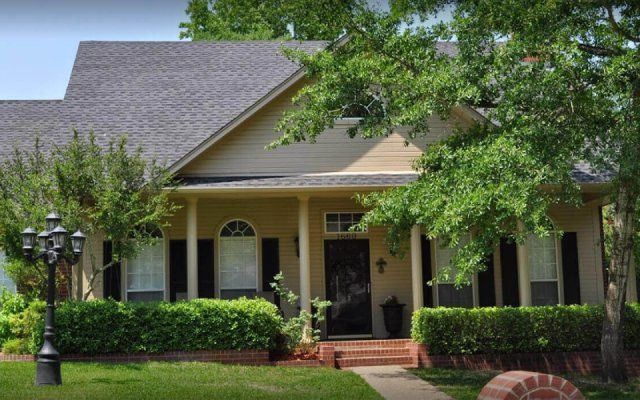 Dark roof house with column porch in East Texas