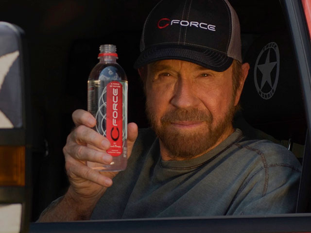Chuck Norris with a bottle of his CForce drinking water
