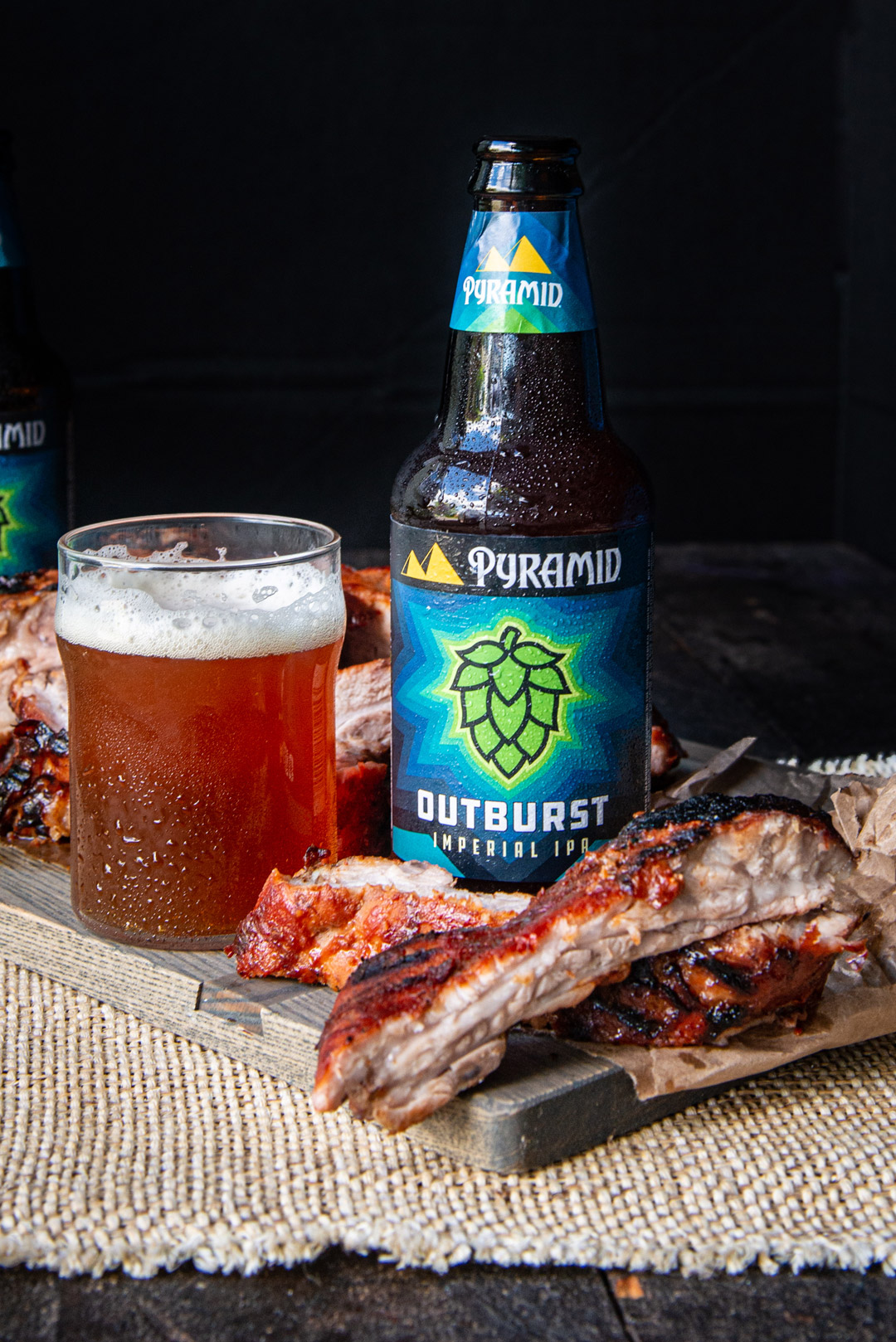 Plate of Sweet and Spicy Outburst IPA Ribs with a bottle of Pyramid Outburst