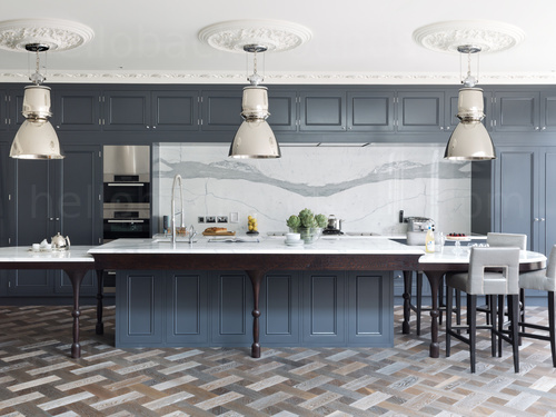 Elegant kitchen decorated in white and dark pastel blue featuring a mosaic style floor and large kitchen island Zoom background
