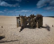 The ruins of a miniature golf castle peak out of the dunes of Jockeys Ridge in Nags Head, North Carolina.