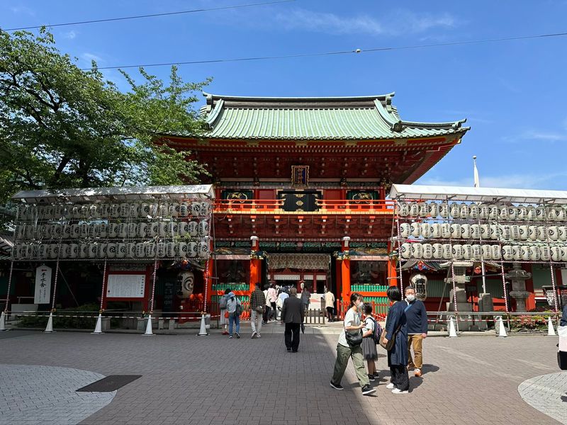 The main gate of Kanda Myojin, a major shrine close to Akihabara. The gate is large and ornate, with lots of red and white wooden structure visible.