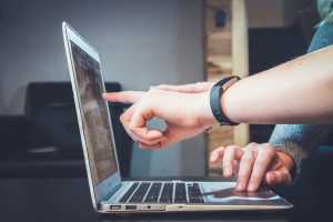 MSP employee pointing out vulnerabilities detected in recent cybersecurity risk assessment for a client