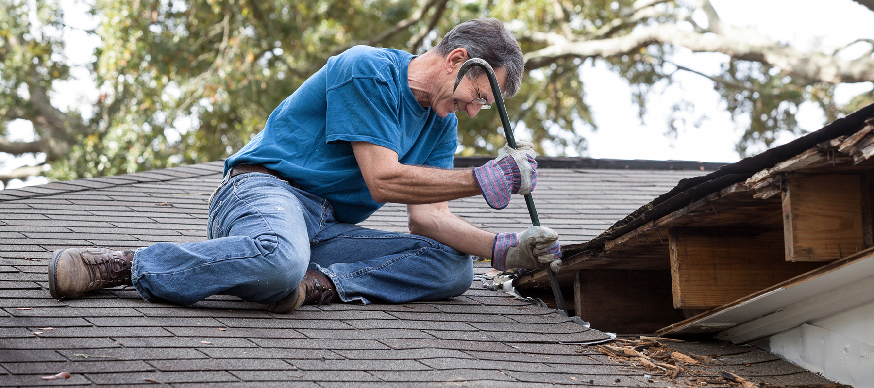 A man on a Roof Doing a Repair
