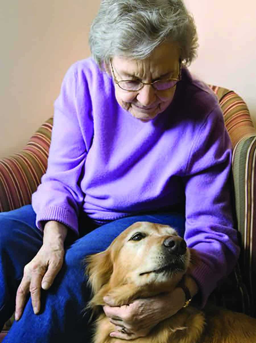 Elderly woman sitting with her dog