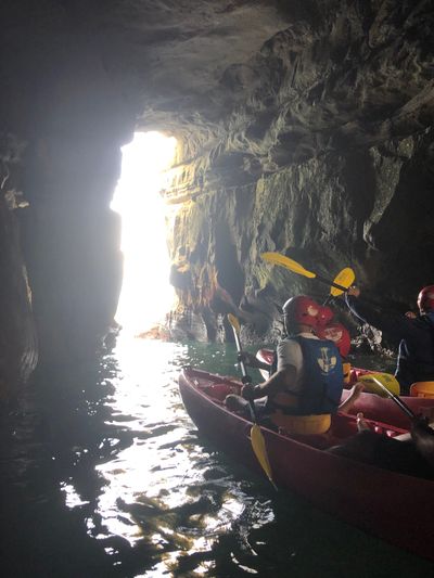 People kayaking in a cavern