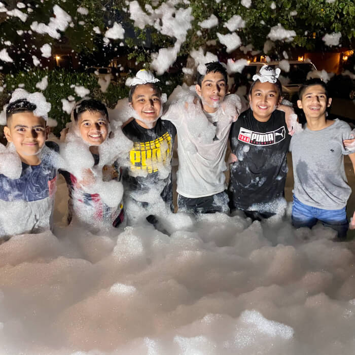 Friends at a foam party.