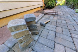 A stone walkway under construction by a hardscaping contractor.