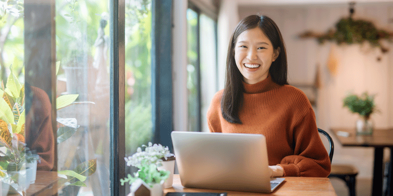 Creating a winning resume for a UX design role A UX designer using her laptop to create a resume