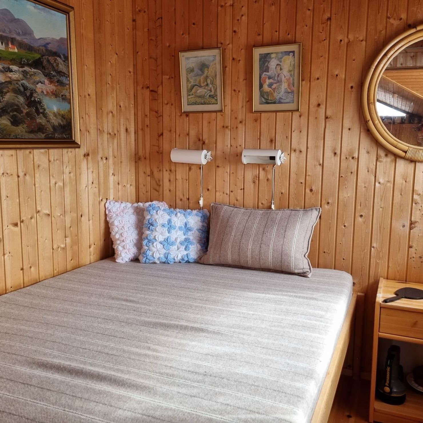 Typisch isländisches Ferienhaus: Holzvertäfeltes Schlafzimmer mit Doppelbett