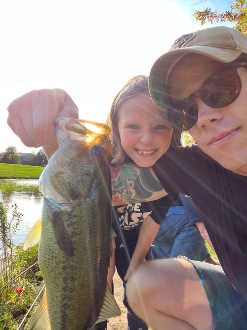 Chris and his daughter show off a recently caught largemouth bass.