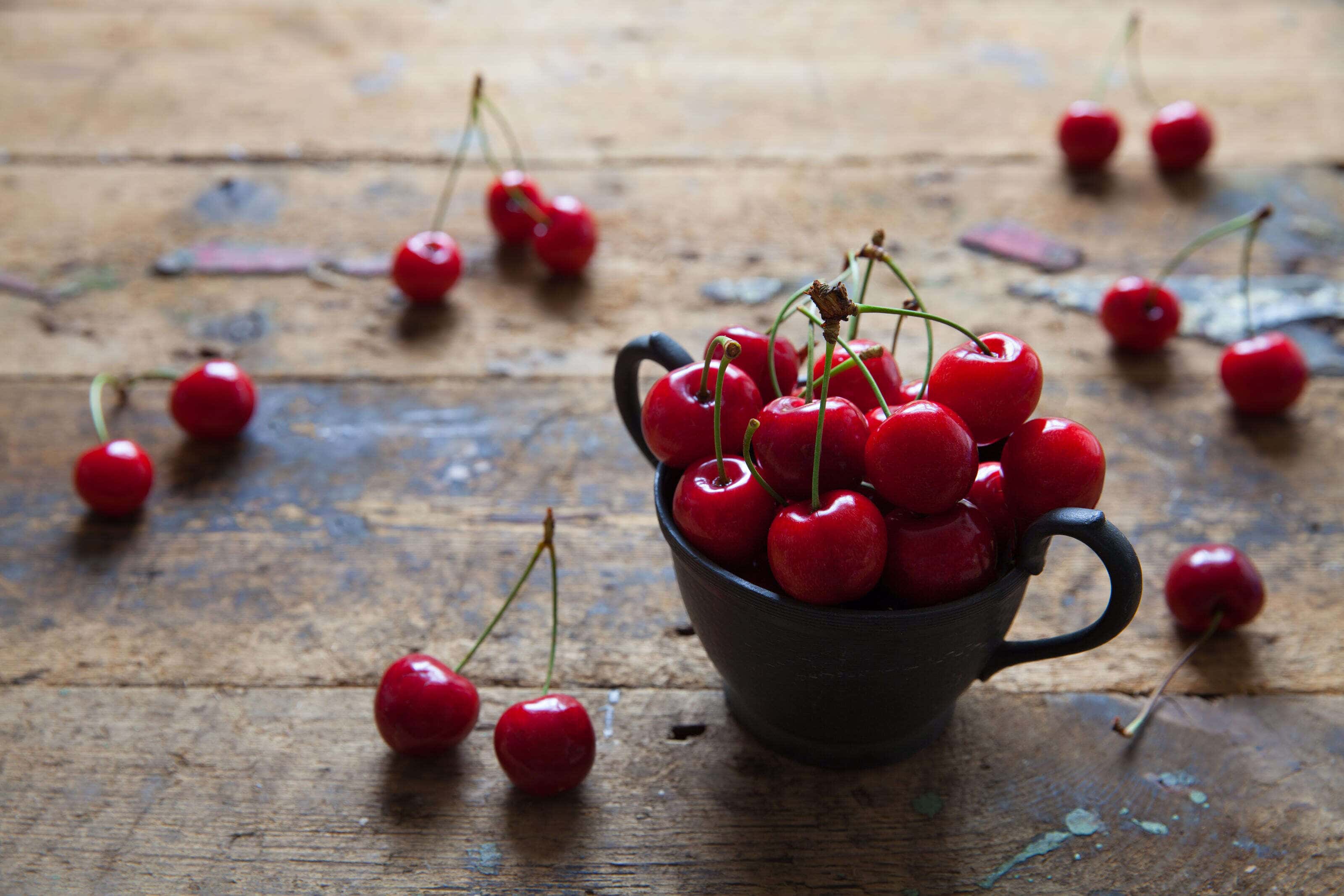 fresh cherries in a pewter pot
