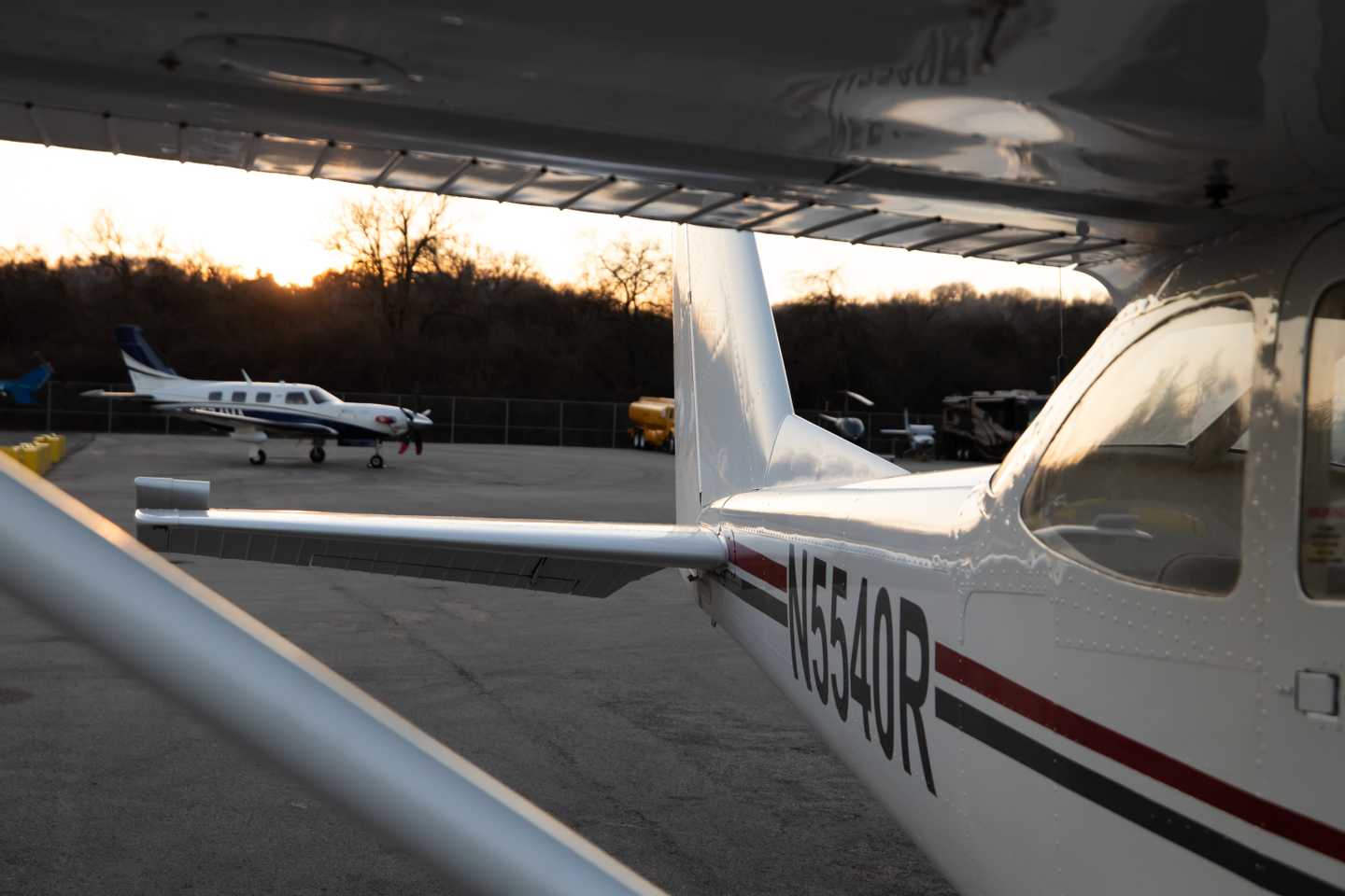 Aircraft on airport ramp at sunset.