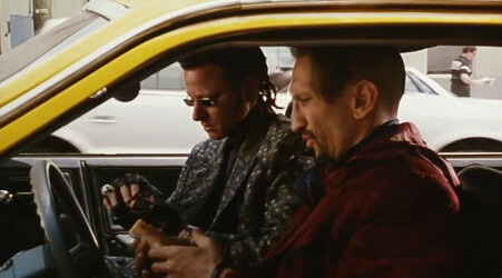 A shot from the Super Mario Bros. movie, showing Iggy and Spike sitting in a taxi cab, about to eat hot-dogs