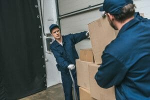 two movers loading boxes for moving services