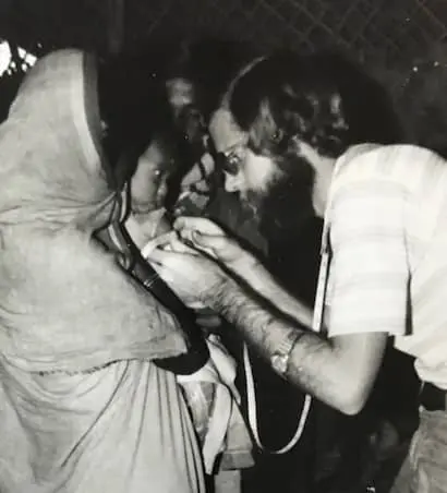 Keith West, checking a young Bangladeshi for signs of malnutrition at a Concern clinic in the 1970s.