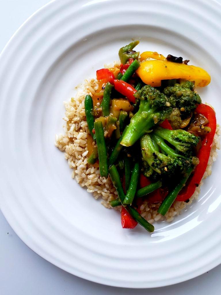 Plate with vegetable stir fry with rice
