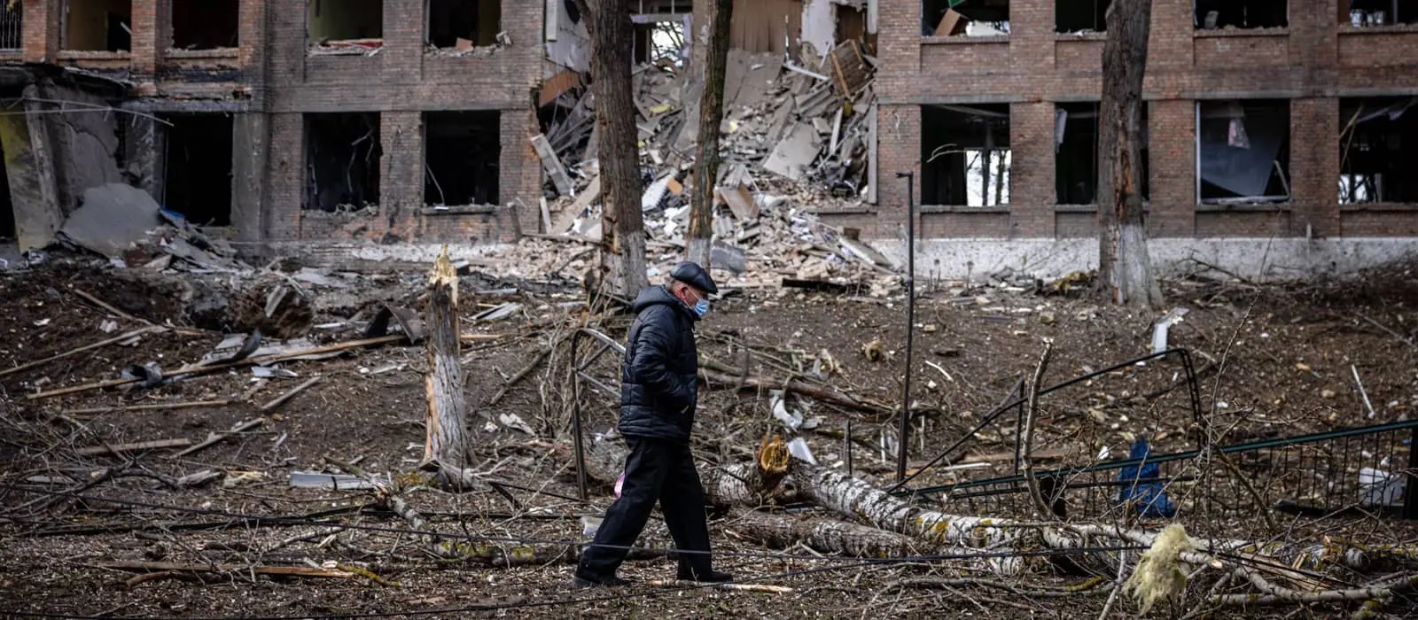 A man walks in front of a destroyed building after a Russian missile attack in the town of Vasylkiv, near Kyiv, on February 27, 2022
