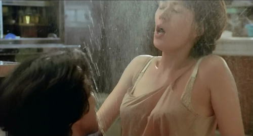 A screenshot of Saeko (played by Misa Shimizu) in a moment of comically wet passion with Kosuke (played by Koji Yakusho) in the film 'Warm Water Under a Red Bridge'.