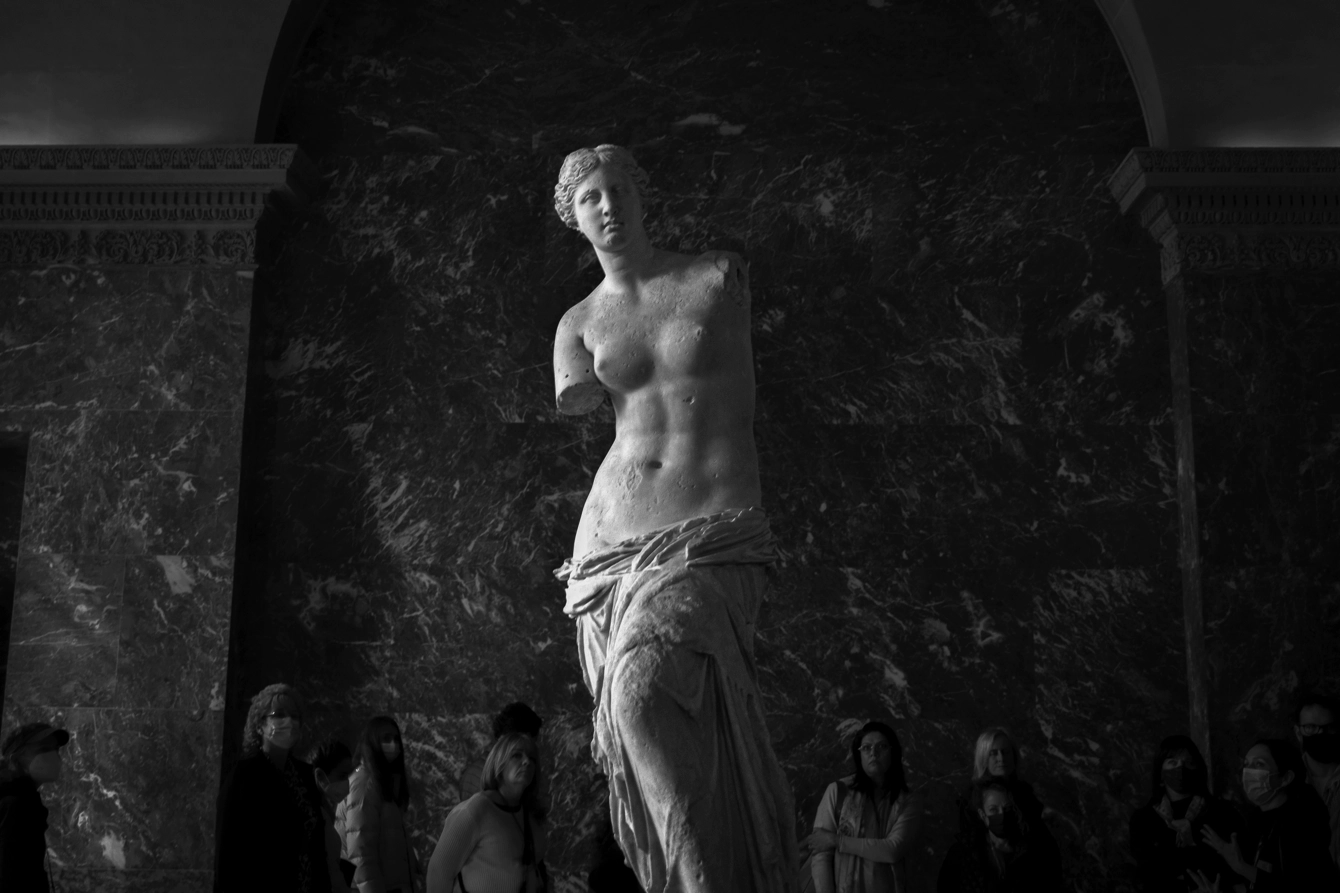 The Venus de Milo in the Louvre, France. The statue’s arms have been removed and she leans off to one side.
