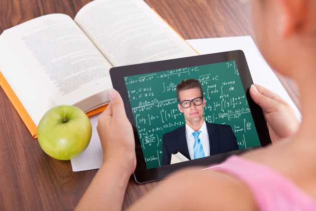 Child attending online lesson on laptop