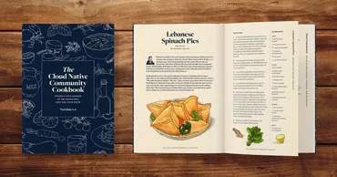 Tableu shot of the cookbook on a wooden table, with the page open to a recipe for Spinach Pies